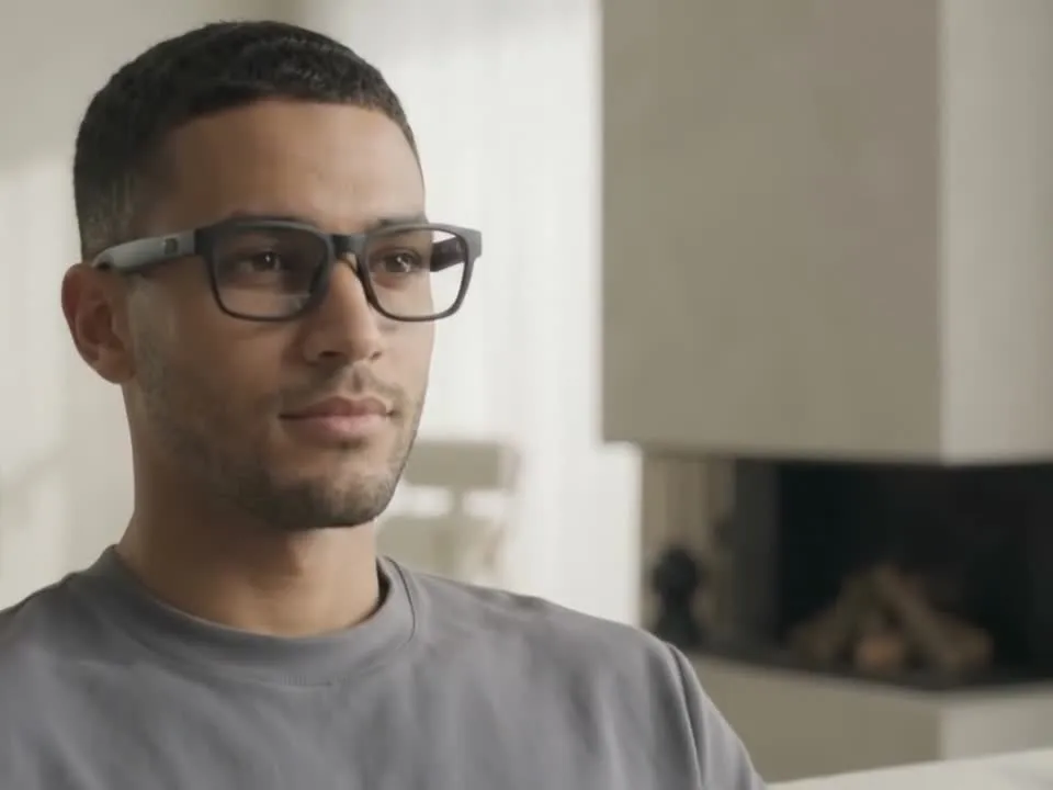 A person wearing MigraMate smart glasses
